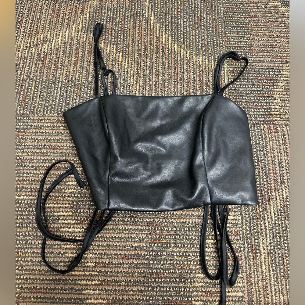 Garage women’s going out black leather top. Ties on back
